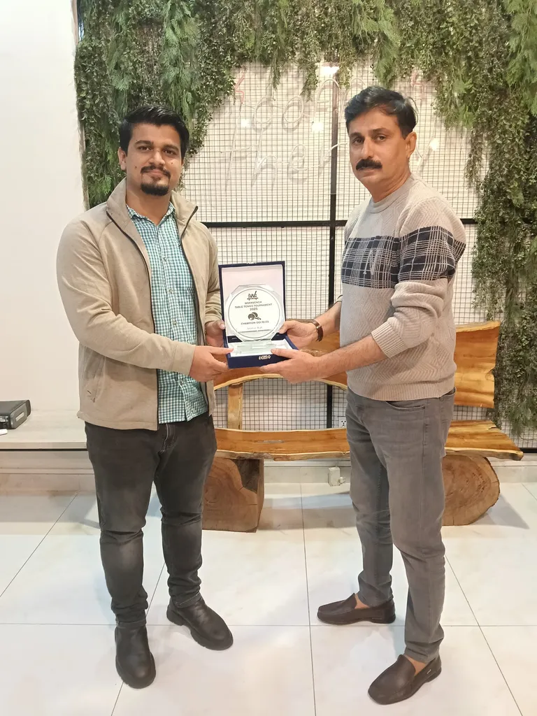 Two members holding an award plaque together in the lounge