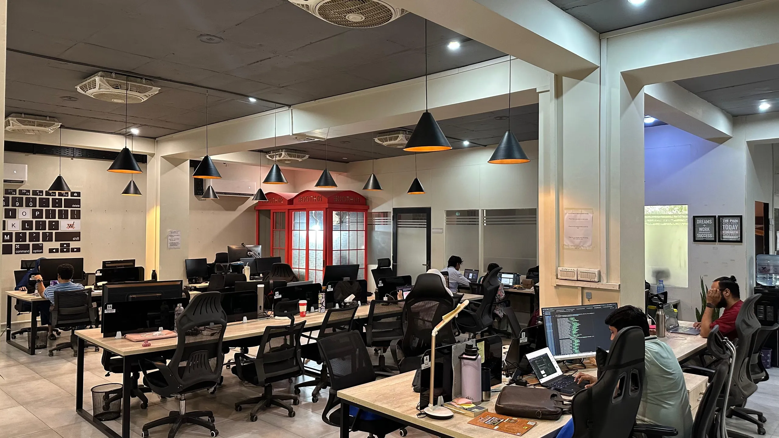 The open floor with the red calling booths marked Booth 01 and Booth 02 along the back wall